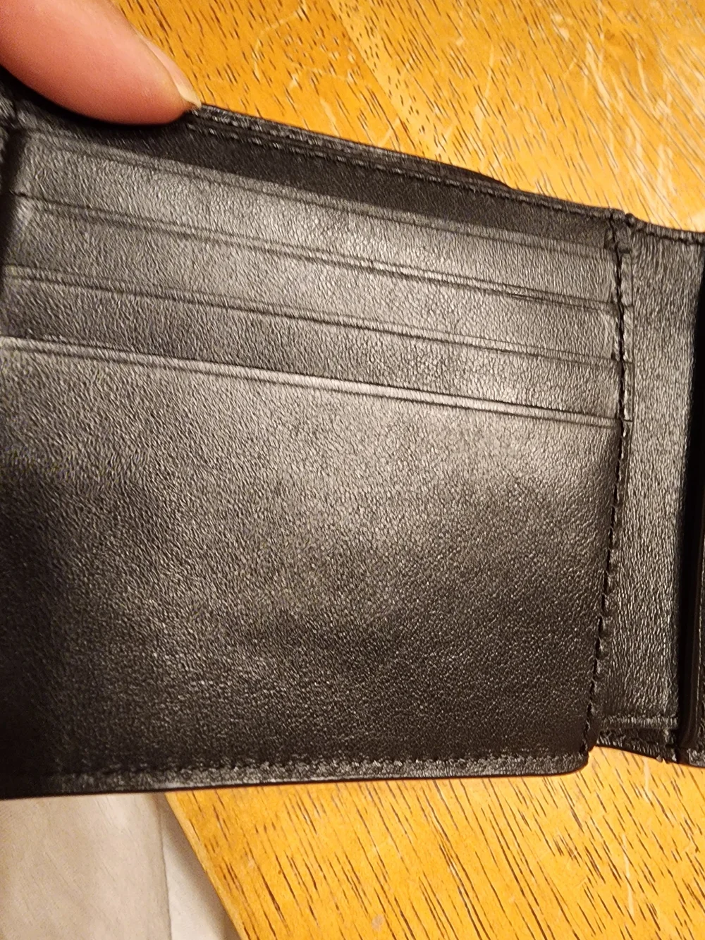 black Coach 3-in-1 wallet featuring the brand's iconic debossed signature pebble